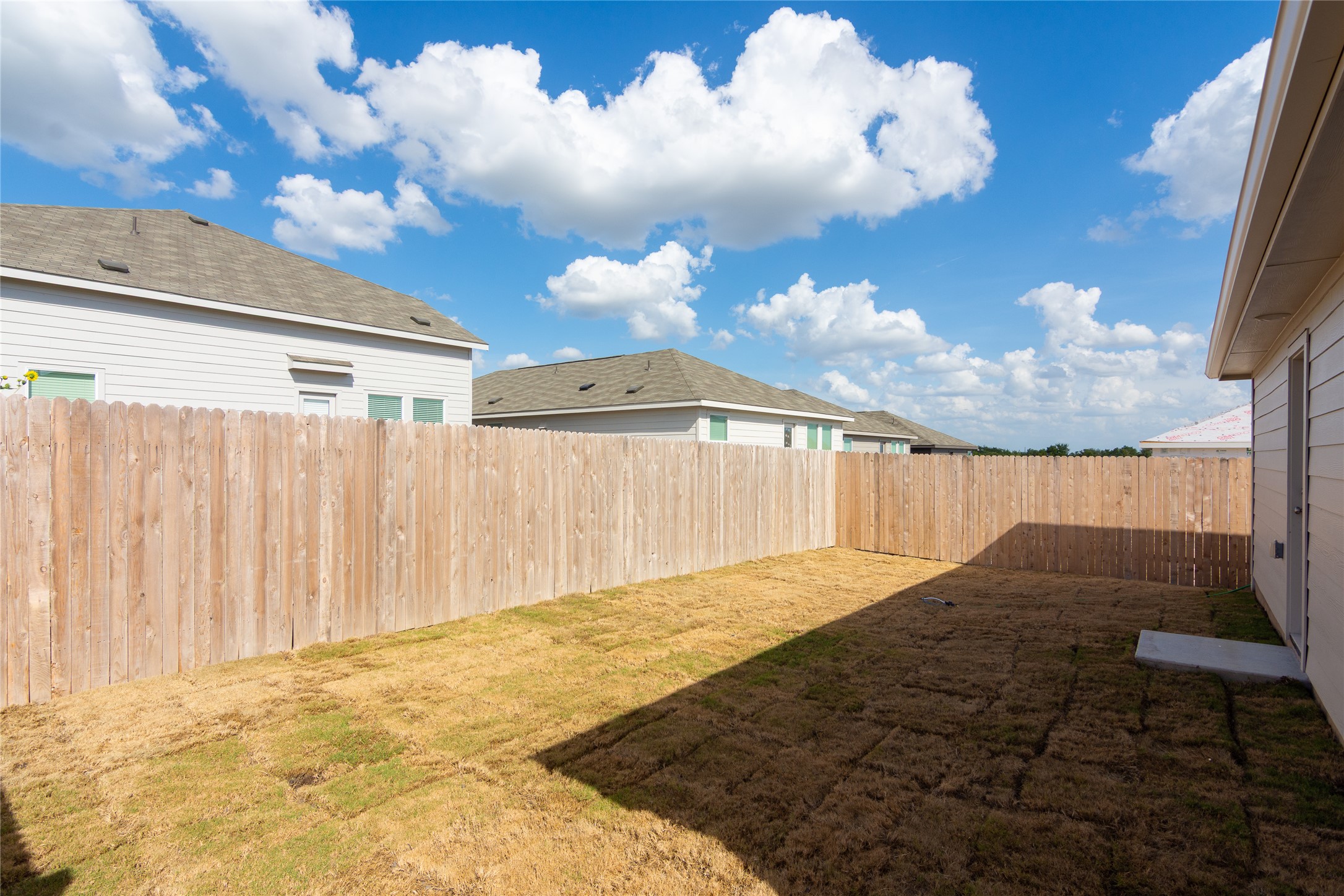 153 Star Packer Lane Jarrell, TX 76537 - Photo 24 of 30 Secure backyard space with a durable wood fence, perfect for private outdoor enjoyment.