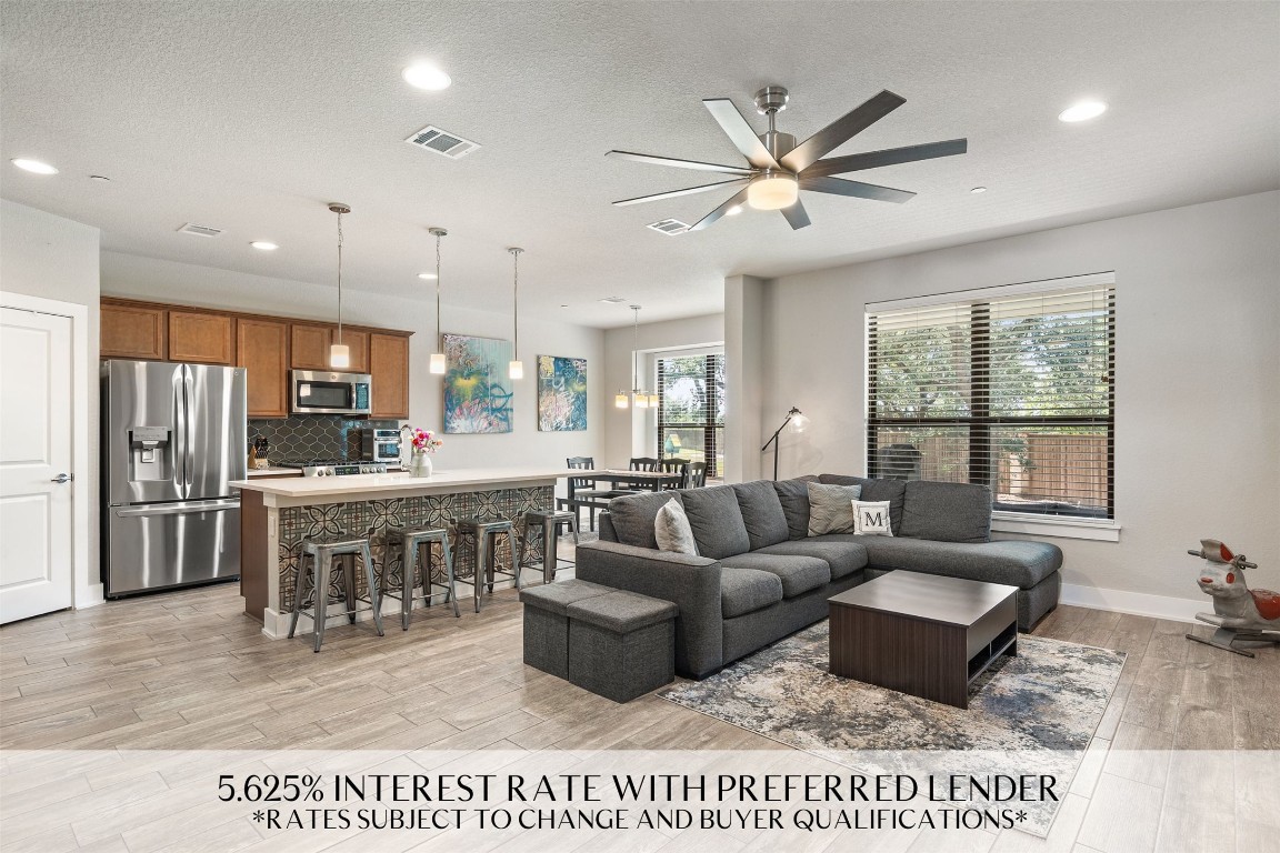 a living room with stainless steel appliances kitchen island granite countertop furniture and a view of kitchen