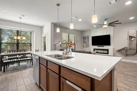 a kitchen with kitchen island a sink dining table and chairs