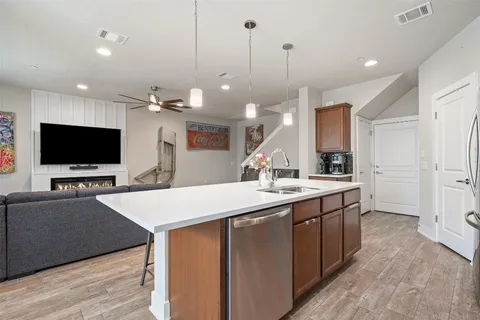 a large kitchen with kitchen island a sink stainless steel appliances and cabinets