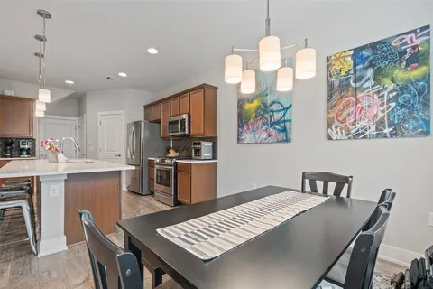 a kitchen with a table chairs and a refrigerator