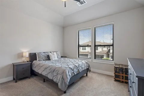 a bedroom with a bed chair and a window
