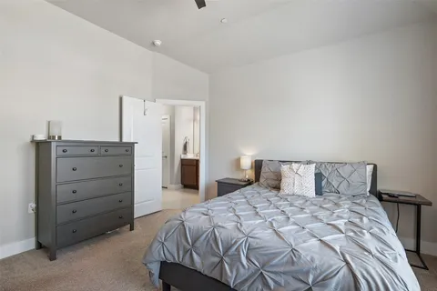 a bedroom with a large bed and a dresser