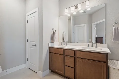 a bathroom with a double vanity sink and mirror