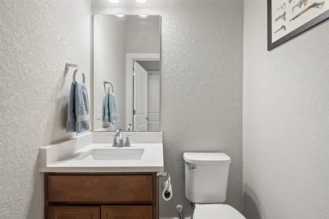 a bathroom with a sink a toilet and mirror