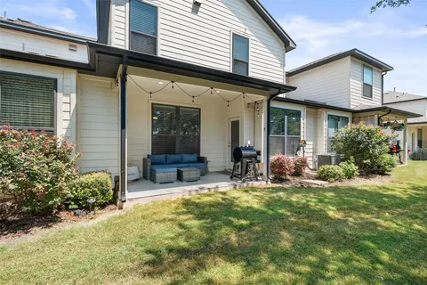 a view of a house with yard and sitting area