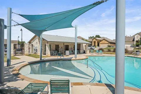 a view of a swimming pool with outdoor seating