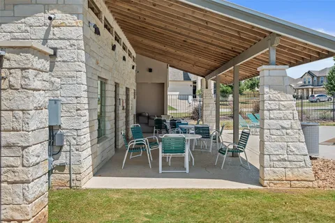 a view of a patio with table and chairs and potted plants