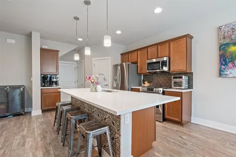 a large kitchen with a table and chairs