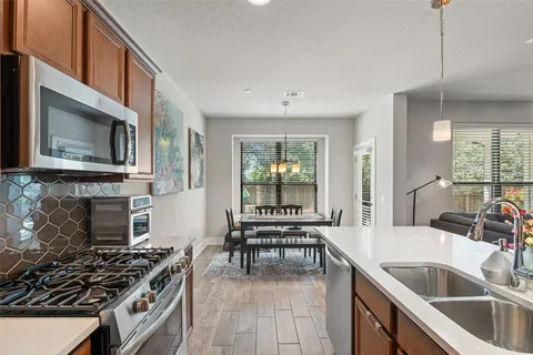 a kitchen with a stove a sink and a microwave