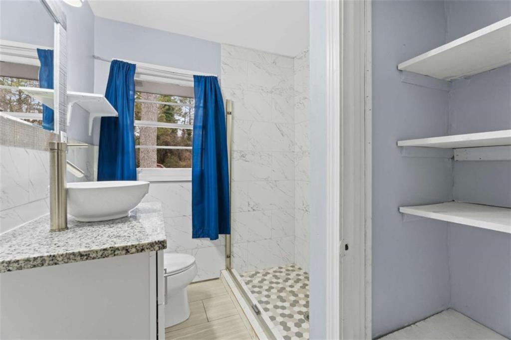 1621 North Columbia Place Decatur, GA 30032 - Photo 24 of 38 a bathroom with a granite countertop sink and a mirror