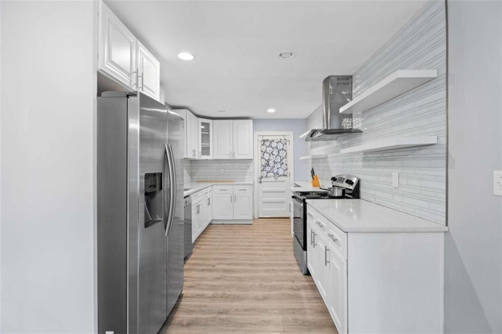 1621 North Columbia Place Decatur, GA 30032 - Photo 8 of 38 a kitchen with stainless steel appliances a refrigerator and a stove top oven