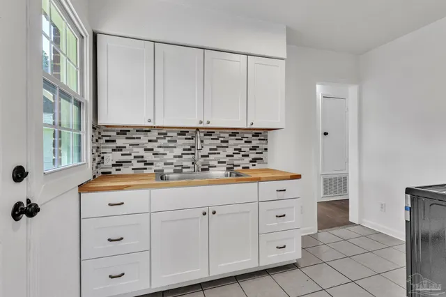 a room with white cabinets and window