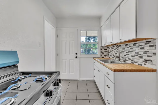 a kitchen with granite countertop a stove and a sink