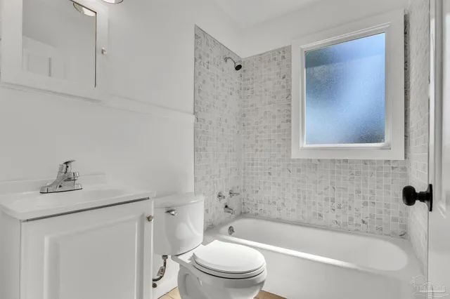 a bathroom with a sink a toilet and bathtub