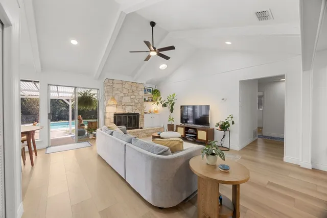a living room with fireplace furniture and a large window
