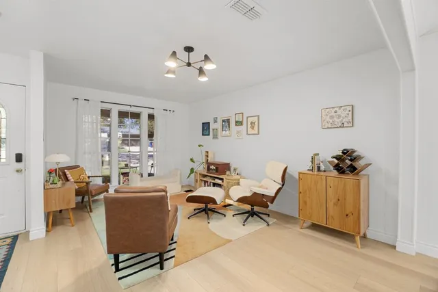 a living room with furniture a rug and a window