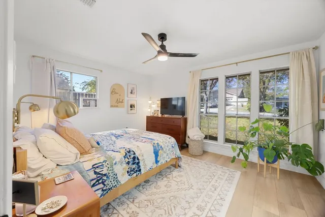 a bedroom with a bed and wooden floor