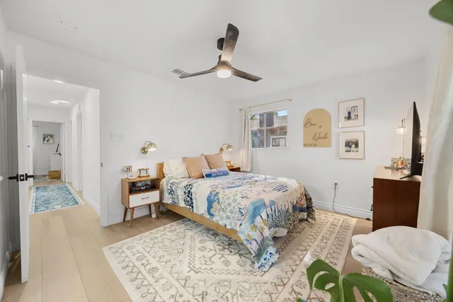 a bedroom with a bed and wooden floor