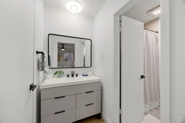 a bathroom with a sink vanity and mirror