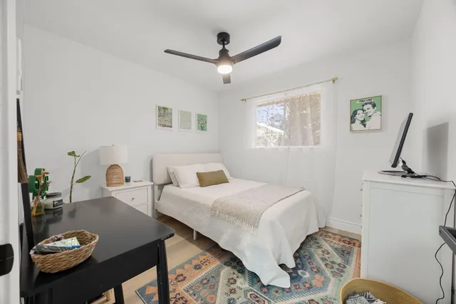 a bedroom with a bed window and couch