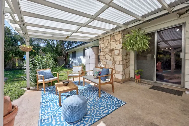 a backyard of a house with outdoor seating