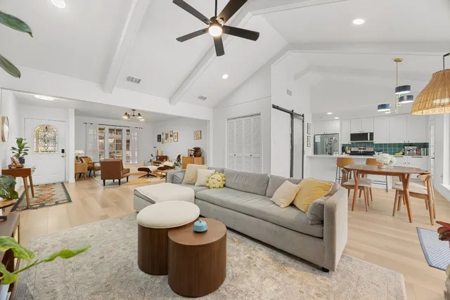 a living room with furniture and kitchen view