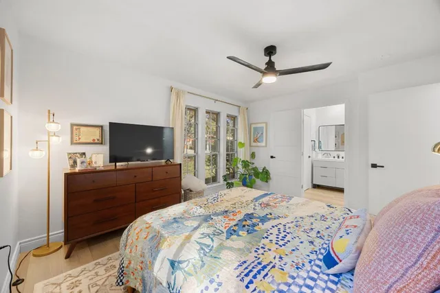 a bedroom with a bed and a flat screen tv