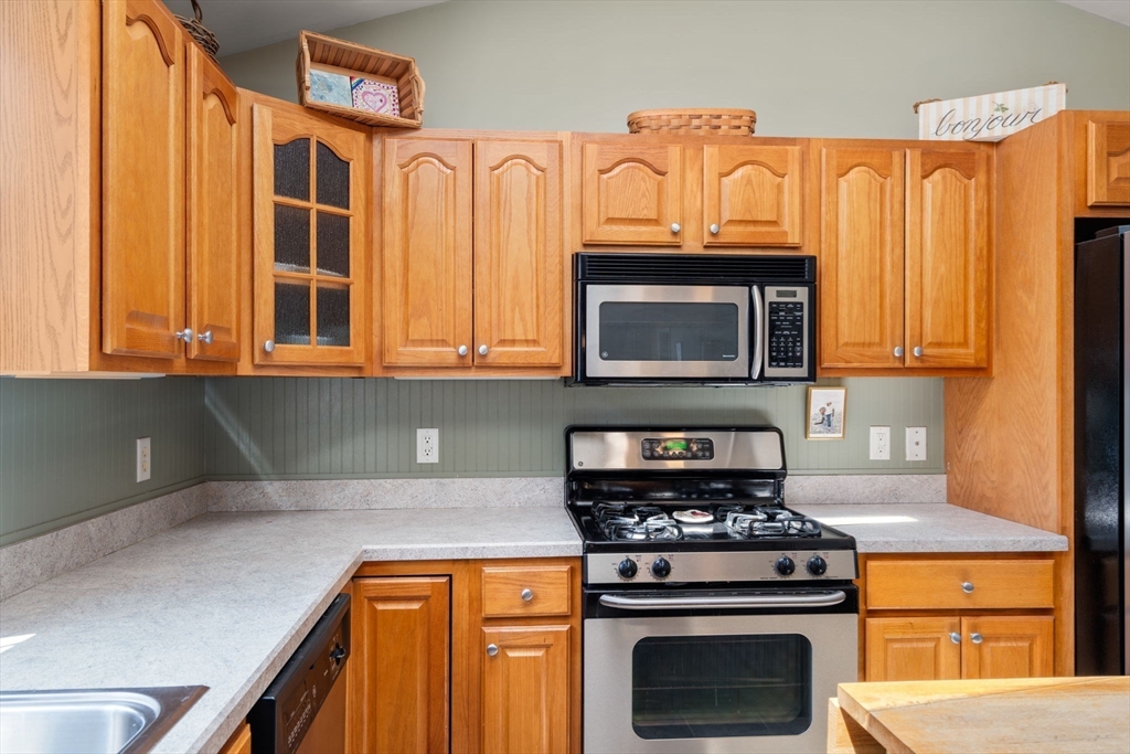 7 Bisbee Drive, Unit 7 Rochester, MA 02770 - Photo 8 of 39 a kitchen with stainless steel appliances granite countertop a stove and a microwave