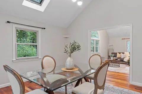a dining room with furniture and wooden floor
