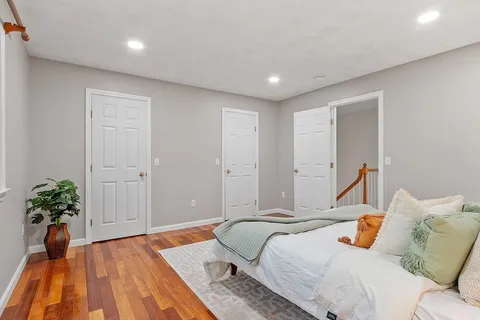 a bedroom with a bed and a potted plant