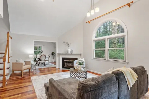 a living room with furniture fireplace and window