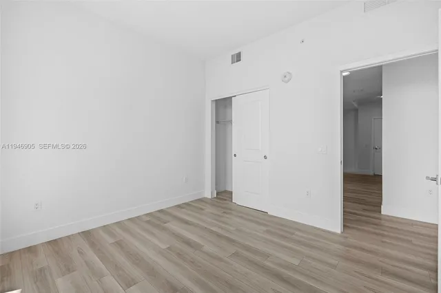 a room with gym equipment and large mirror