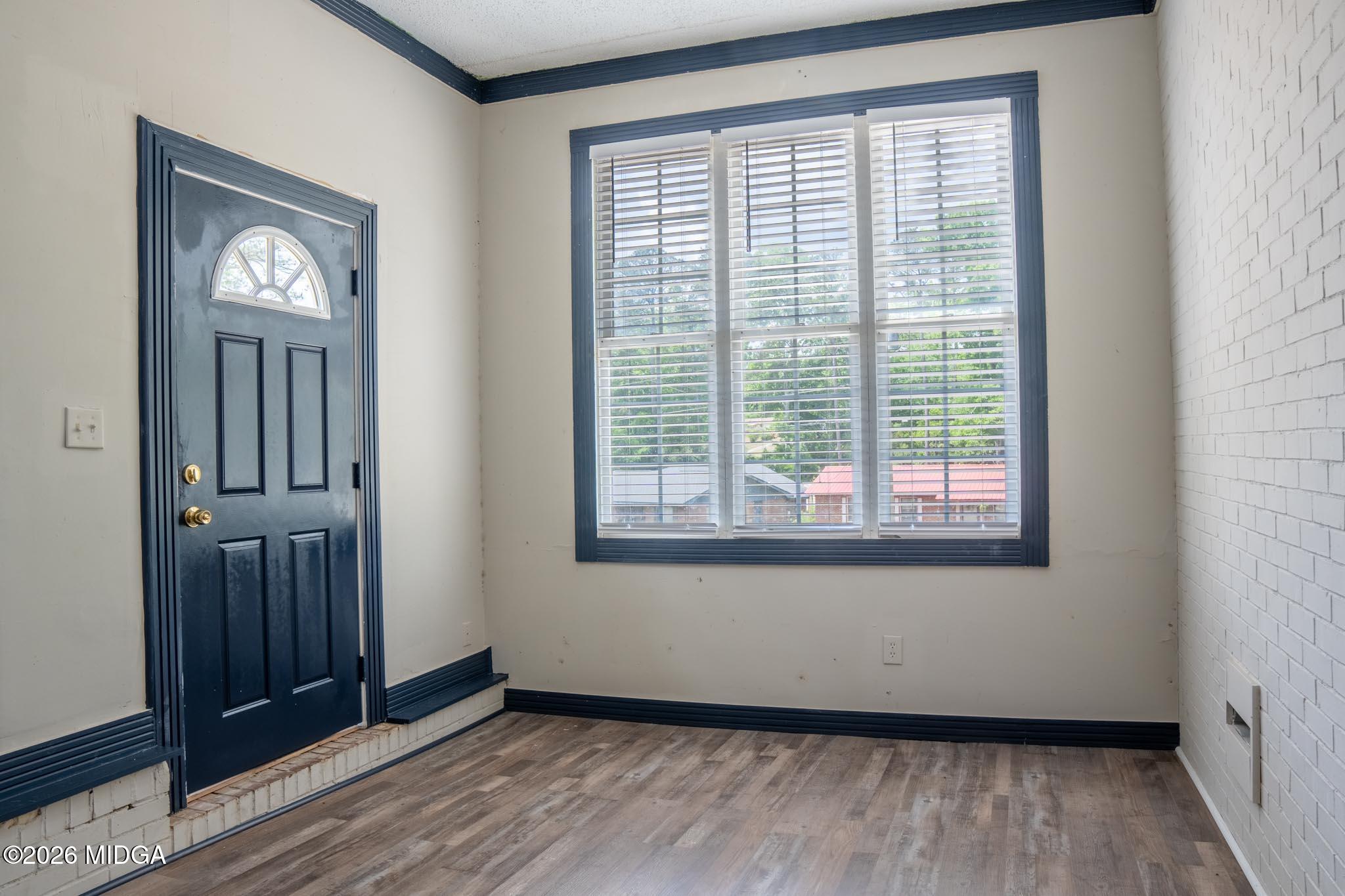 3319 Mohawk Road Macon, GA 31217 - Photo 33 of 38 a view of an empty room with wooden floor and a window