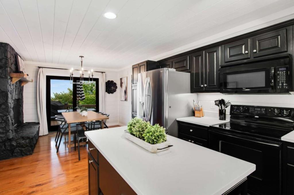 231 Sunrock Mountain Trail Blue Ridge, GA 30513 - Photo 17 of 61 a kitchen with stainless steel appliances a stove refrigerator sink and cabinets