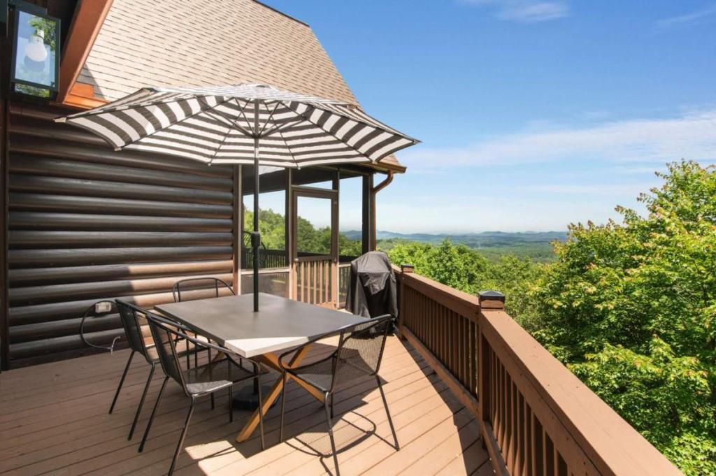 231 Sunrock Mountain Trail Blue Ridge, GA 30513 - Photo 26 of 61 a view of a chairs and table in patio with wooden fence
