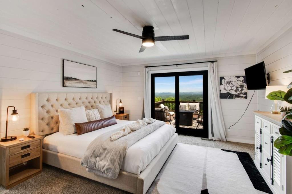 231 Sunrock Mountain Trail Blue Ridge, GA 30513 - Photo 29 of 61 a bedroom with bed and a flat tv screen on dresser