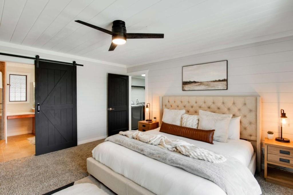 231 Sunrock Mountain Trail Blue Ridge, GA 30513 - Photo 30 of 61 a bedroom with a large bed and a chandelier