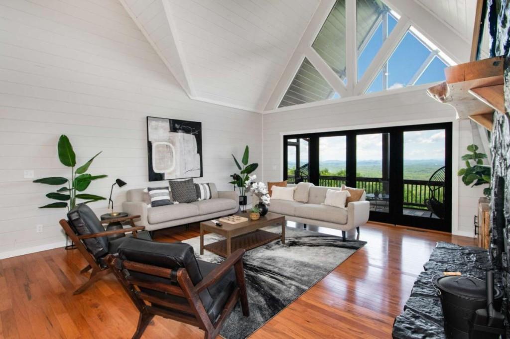 231 Sunrock Mountain Trail Blue Ridge, GA 30513 - Photo 9 of 61 a living room with furniture large wooden floor and a large window