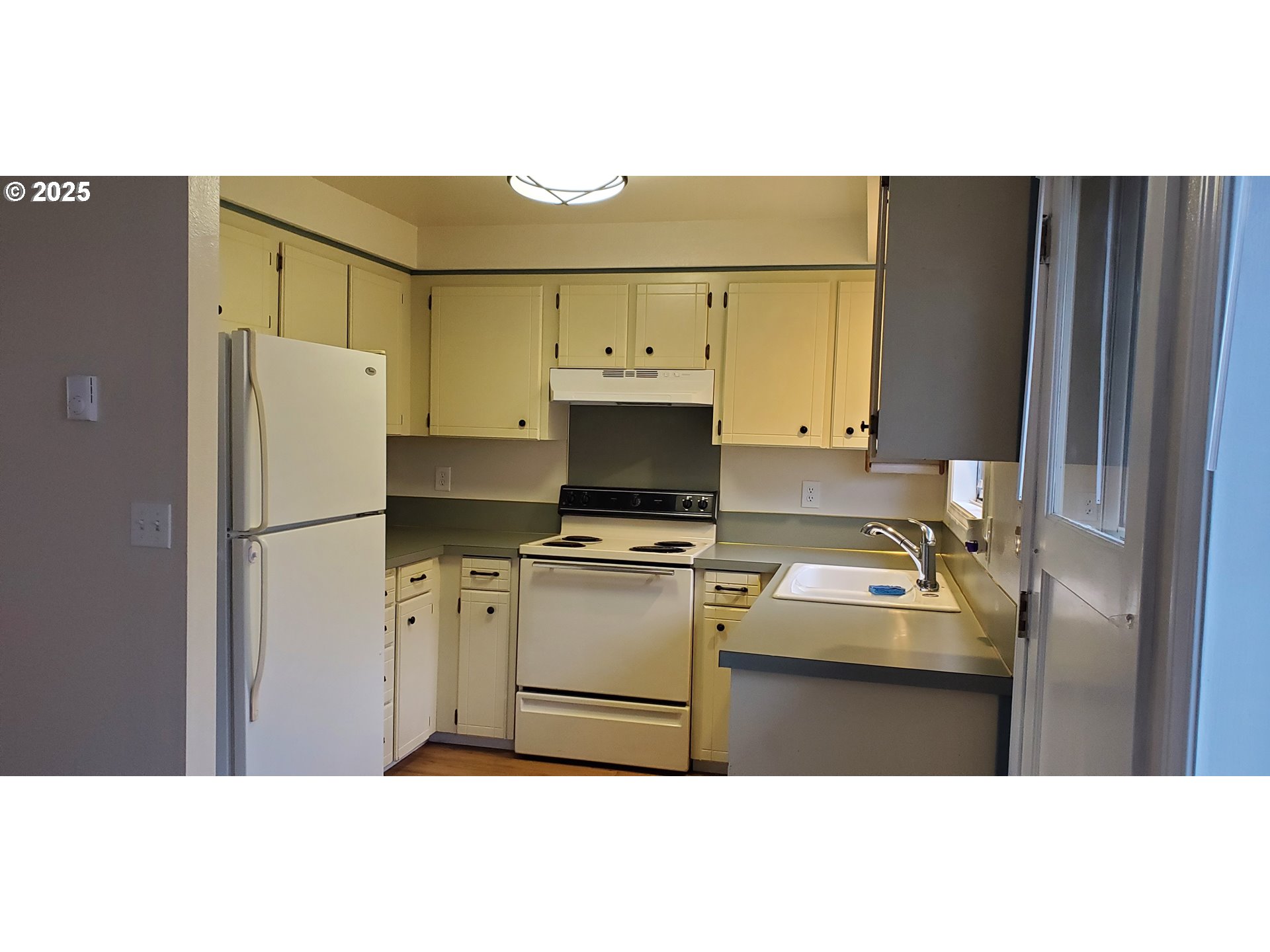 101 Ash Street Ridgefield, WA 98642 - Photo 4 of 15 a kitchen with refrigerator and cabinets
