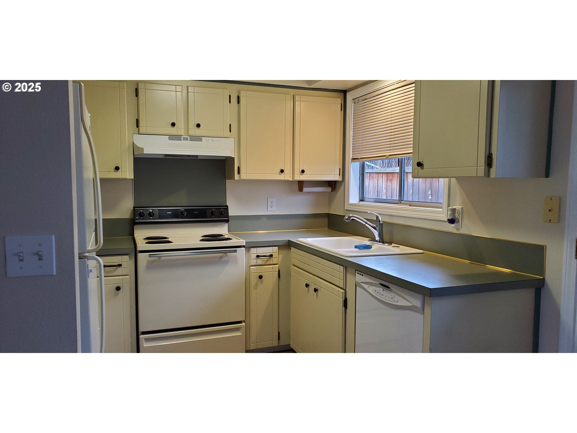 101 Ash Street Ridgefield, WA 98642 - Photo 5 of 15 a kitchen with a sink a microwave and cabinets
