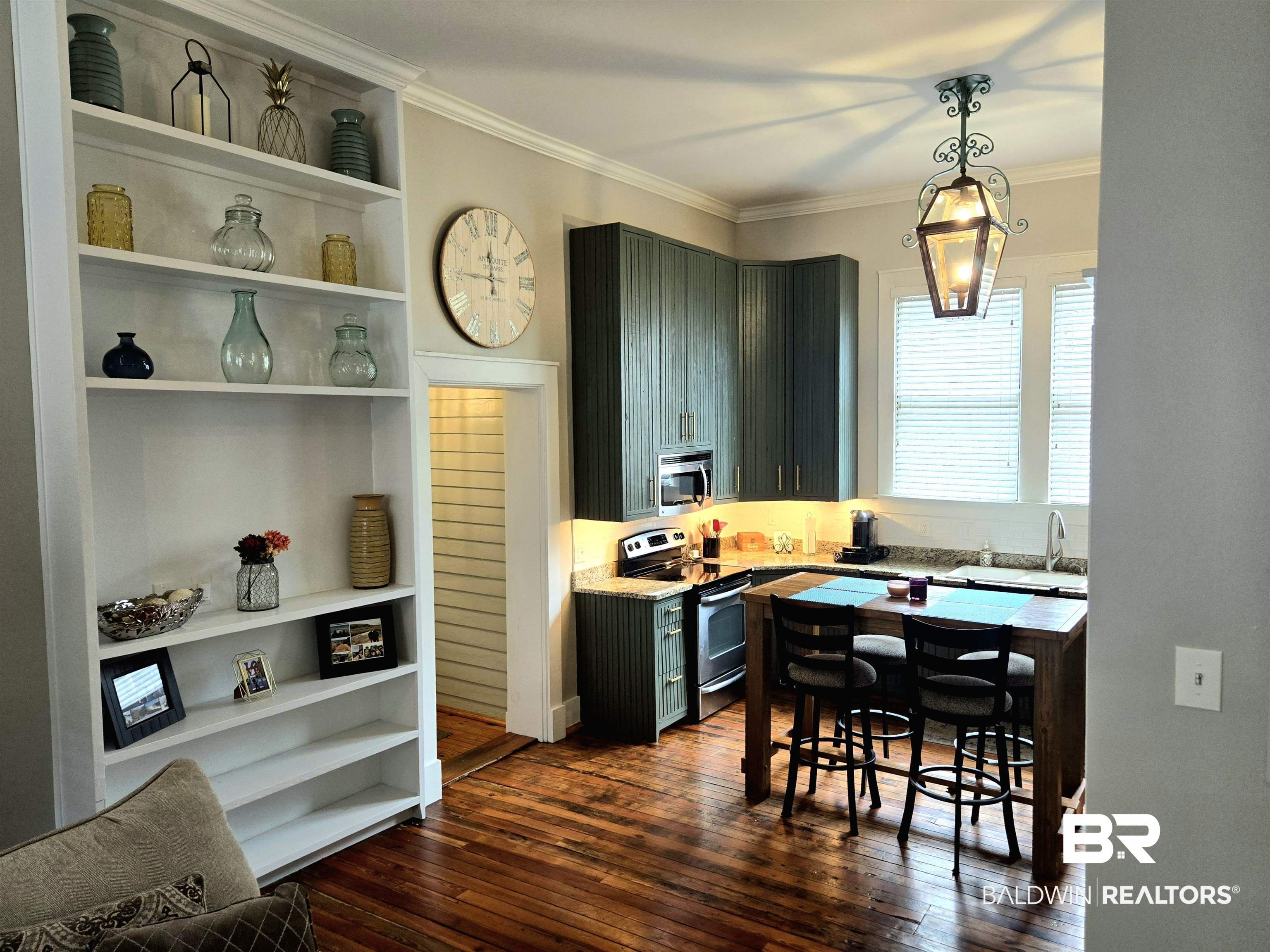 54 South Catherine Street Mobile, AL 36604 - Photo 18 of 55 Kitchen featuring stainless steel appliances, open shelves, dark wood-style flooring, crown molding, and pendant lighting