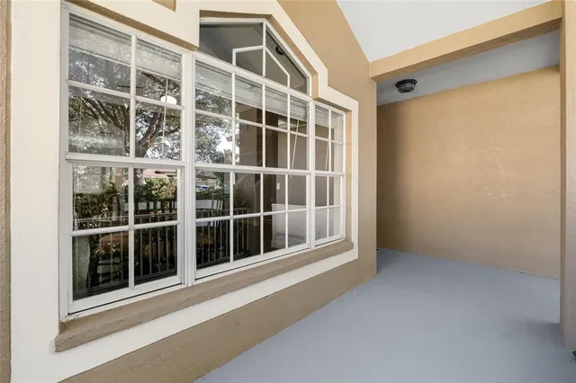 a living room with furniture kitchen view and a chandelier