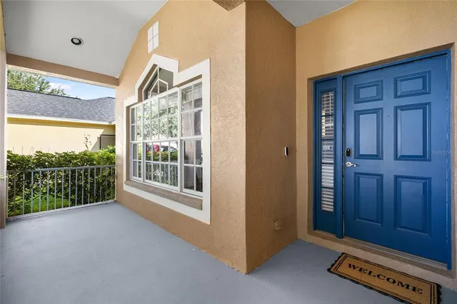 a living room with couches and a ceiling fan with wooden floor