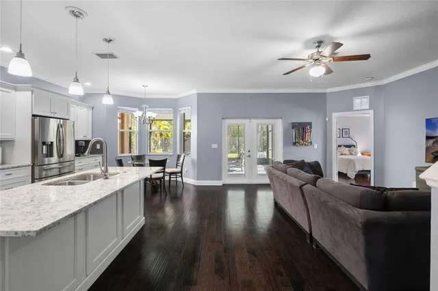a kitchen with a sink stove a dining table and chairs