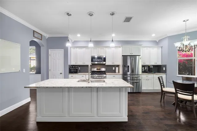 a view of a livingroom with a ceiling fan and entryway