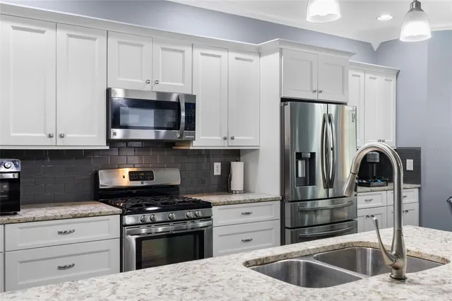 a bedroom with a large bed and wooden floor