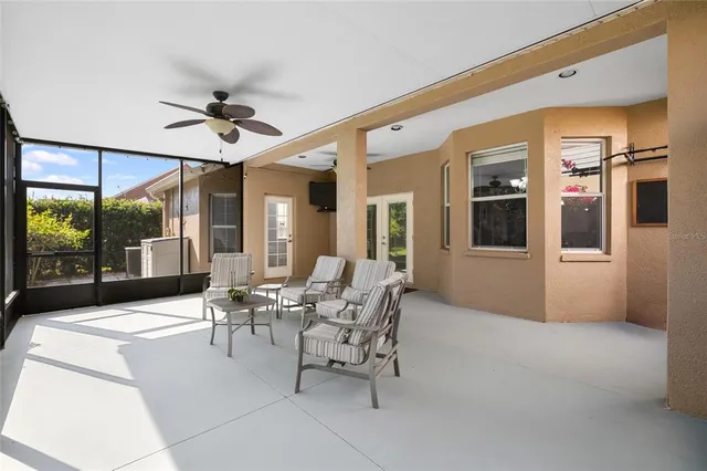 an aerial view of a house with a yard and large trees