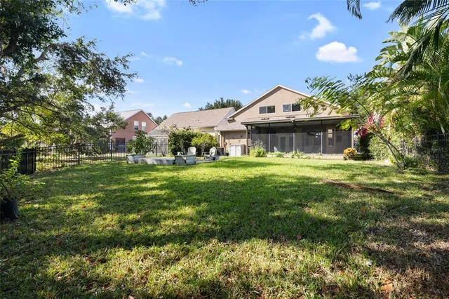 a view of a tennis ground with large trees