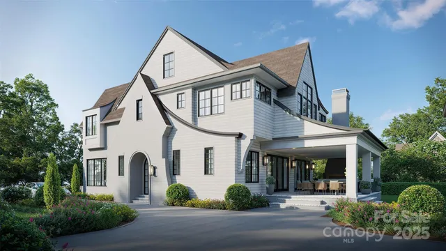 a view of a white house with a yard and plants